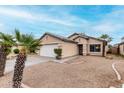 Single-story home with desert landscaping, two-car garage and tile roof at 15835 W Woodlands Ave, Goodyear, AZ 85338