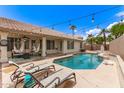 Inviting backyard with a sparkling pool, lounge chairs, and a covered patio area at 16023 S 30Th Pl, Phoenix, AZ 85048
