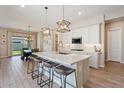 Open-concept kitchen with island seating, stainless steel appliances, and access to dining area at 1895 N 141St Ave, Goodyear, AZ 85395
