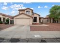 Inviting two-story home featuring a desert landscape, attached two-car garage, and neutral toned exterior paint at 20440 N 39Th Dr, Glendale, AZ 85308