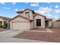 Inviting two-story home featuring a desert landscape, attached two-car garage, and neutral toned exterior paint at 20440 N 39Th Dr, Glendale, AZ 85308