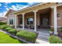Inviting front porch with swing, seating, and lush landscaping at 20585 W Garden St, Buckeye, AZ 85396