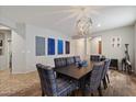 Dining room with stylish lighting fixture and plaid dining chairs at 2328 W Calle Marita --, Phoenix, AZ 85085