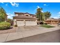 Charming two-story home with three-car garage, drought-resistant landscaping, and a bright blue sky at 2440 E Stephens Pl, Chandler, AZ 85225