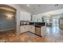 Open kitchen showcasing white cabinets, granite countertops, and a stainless steel dishwasher at 2735 E Flower Ct, Gilbert, AZ 85298