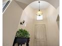 Bright foyer with chandelier lighting, high ceilings, neutral paint, and a decorative plant at 30248 W Earll Dr, Buckeye, AZ 85396