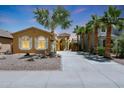 Inviting single-story home with manicured landscaping and a long private driveway, surrounded by palm trees at 30248 W Earll Dr, Buckeye, AZ 85396