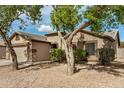 Attractive single-story home featuring a two-car garage, neutral paint, stone accents and tidy landscaping at 3029 N 83Rd Ln, Phoenix, AZ 85037