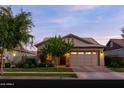 Charming home featuring a well-manicured front yard, stone accents, and a two-car garage at 3437 E Appaloosa Rd, Gilbert, AZ 85296