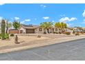 Spacious home with a gated driveway, desert landscaping, and solar panels on the roof at 37508 N 12Th St, Phoenix, AZ 85086