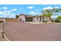 Home with a gated driveway and desert landscaping; solar panels can be seen on the roof at 37508 N 12Th St, Phoenix, AZ 85086