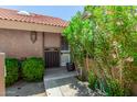 Charming entryway with lush greenery and a secure screen door at 4033 E Larkspur Dr, Phoenix, AZ 85032