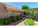 Inviting home exterior with lush, mature landscaping and a charming tile roof at 4033 E Larkspur Dr, Phoenix, AZ 85032