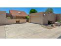 Home exterior features a two-car garage, large driveway, and low-maintenance landscaping at 4033 E Larkspur Dr, Phoenix, AZ 85032
