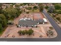 Expansive aerial view of estate featuring pool, tennis court, mature landscaping, and circular driveway at 4107 E Fairview Cir, Mesa, AZ 85206