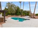 Backyard pool with surrounding concrete pool deck and shade trees at 4107 E Fairview Cir, Mesa, AZ 85206