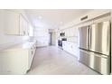 Beautifully remodeled kitchen featuring white cabinets, stainless appliances, and ample counter space at 4528 W Butler Dr, Glendale, AZ 85302