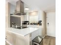 Bright kitchen with stainless steel appliances, white cabinets, tile backsplash, and modern fixtures at 4630 N 68Th St # 221, Scottsdale, AZ 85251