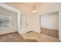 Neutral toned entryway with tiled floors, coat closet, and access to other rooms at 5502 N Ormondo Way, Litchfield Park, AZ 85340