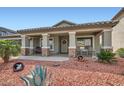 Single story home showing front porch with stone accents and desert landscaping at 5502 N Ormondo Way, Litchfield Park, AZ 85340