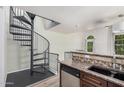 Kitchen area highlighting granite countertops, modern appliances, and a unique spiral staircase nearby at 5757 S 21St Ter, Phoenix, AZ 85040