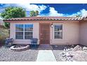 Inviting front of home with seating area, security door and well maintained desert landscape at 5941 W Venus Way, Chandler, AZ 85226