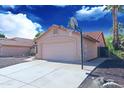 Attached two-car garage with concrete driveway and basketball hoop at 5941 W Venus Way, Chandler, AZ 85226