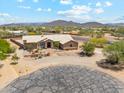 Expansive aerial view of desert home with desert landscaping and mountain views at 616 E Lavitt Ln, Phoenix, AZ 85086