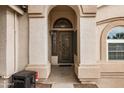 Close up of the front door with decorative ironwork and arched detailing at 662 S Saddle St, Gilbert, AZ 85233