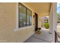 Welcoming front porch with a cozy entrance, decorative pillars, and a 'Welcome Home' mat at 6907 S 8Th Dr, Phoenix, AZ 85041