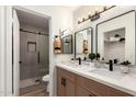 Beautifully renovated bathroom with dual sinks, modern fixtures, and a glass-enclosed shower at 701 W Mesquite St, Chandler, AZ 85225