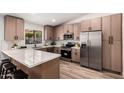 Bright kitchen featuring stainless steel appliances, wooden cabinets, and a marble countertop at 701 W Mesquite St, Chandler, AZ 85225