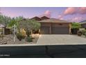 Charming home with a three-car garage, mature trees, and desert landscaping at 7144 E San Cristobal Way, Gold Canyon, AZ 85118