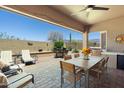 Expansive covered patio with outdoor kitchen, dining, and lounge seating, perfect for entertaining at 7144 E San Cristobal Way, Gold Canyon, AZ 85118