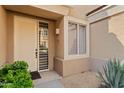 Inviting front entryway with a decorative door, side window and manicured shrubbery at 7887 N 16Th St # 226, Phoenix, AZ 85020