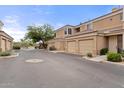 Street view of attached garages and individual entrances to townhomes in a gated community at 7887 N 16Th St # 226, Phoenix, AZ 85020