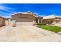 Charming single-story home with a tile roof, manicured lawn, and a two-car garage on a sunny day at 7930 W Wescott Dr, Glendale, AZ 85308