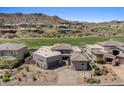 Expansive home featuring desert landscaping surrounded by green golf course and mountainous background at 9432 N Longfeather --, Fountain Hills, AZ 85268