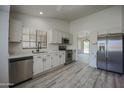 Open kitchen featuring stainless steel appliances, plenty of counter space, and sleek cabinets at 9813 W Mcrae Way, Peoria, AZ 85382