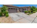 Large concrete driveway leading to the garage and accented by manicured landscaping at 9922 E Thunderbolt Ave, Mesa, AZ 85212