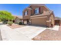 Charming two-story home features a two-car garage and well-maintained front yard with stone pathway at 10745 W Taft St, Phoenix, AZ 85037