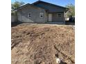 An exterior shot of a cozy home with stucco walls and a freshly cleared yard at 1110 E Pierce St, Phoenix, AZ 85006
