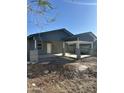 An exterior shot of a house with stucco walls, fresh concrete, and a covered carport at 1110 E Pierce St, Phoenix, AZ 85006