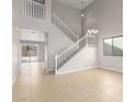 Bright living room features soaring ceilings, staircase, and tile floors at 11132 W Mariposa Dr, Phoenix, AZ 85037