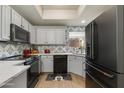 Bright kitchen boasting stainless steel appliances, sleek white cabinetry, and a modern backsplash at 11680 E Sahuaro Dr # 1059, Scottsdale, AZ 85259
