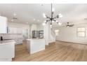 Kitchen and Living space featuring stainless steel appliances, white cabinets, and pendant lights at 1265 S Aaron -- # 271, Mesa, AZ 85209