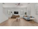 Bright living room with a ceiling fan, stylish furniture, and large windows offers a modern comfortable feel at 1265 S Aaron -- # 271, Mesa, AZ 85209