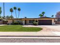Charming single story home with landscaped front yard, desert landscaping, and brick driveway at 1535 E Kenwood St, Mesa, AZ 85203
