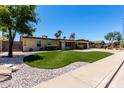 Charming single story home with landscaped front yard, desert landscaping, and brick driveway at 1535 E Kenwood St, Mesa, AZ 85203