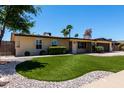 Charming single story home with landscaped front yard, desert landscaping, and brick driveway at 1535 E Kenwood St, Mesa, AZ 85203